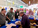 ARRL Radiosport Manager Norm Fusaro, W3IZ (right), handled DXCC card-checking at Friedrichshafen. [Bob Inderbitzen, NQ1R, photo]